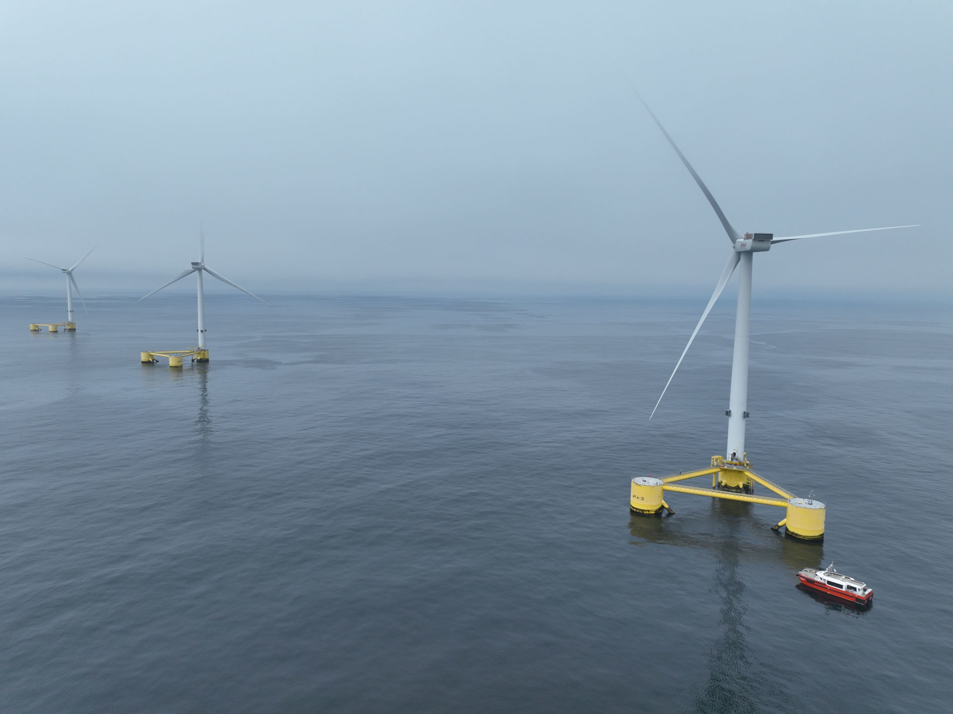 picture showing three floating wind turbines next to each other in the water